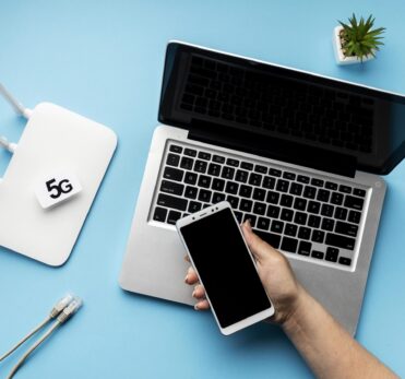 top-view-wi-fi-router-with-laptop-hand-holding-smartphone
