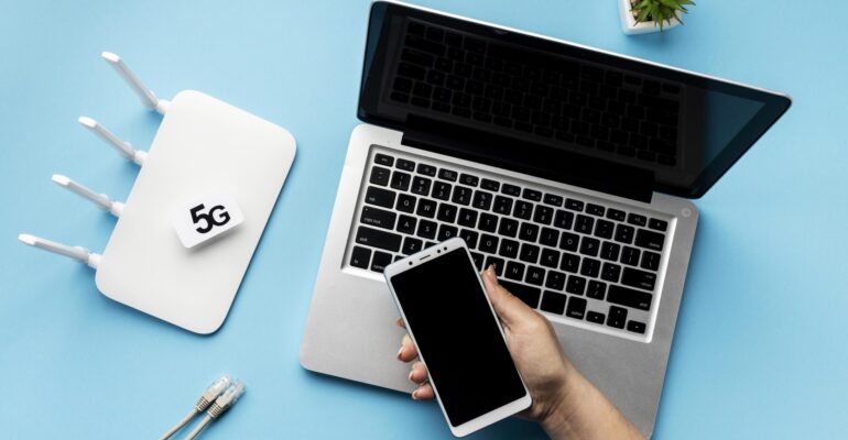 top-view-wi-fi-router-with-laptop-hand-holding-smartphone